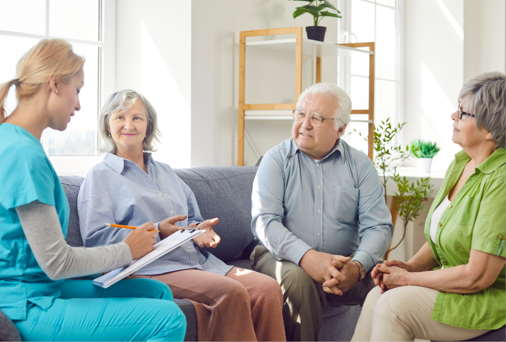 Nurse speaking with group of older people.